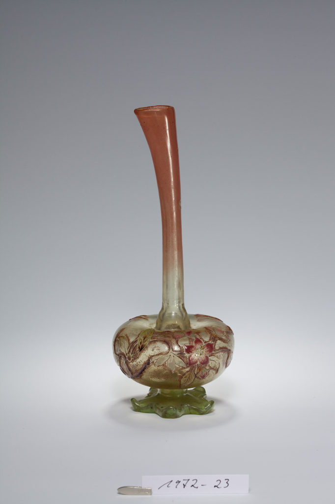 Vase mit Blüten und fliegendem Insekt